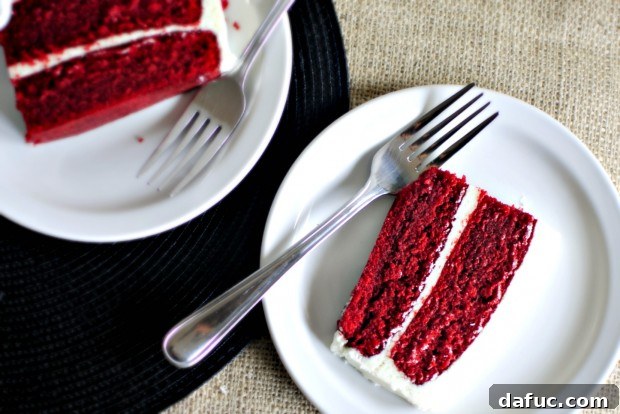 Timeless Red Velvet Cake 31 A whole Classic Red Velvet Cake beautifully frosted with cream cheese frosting, inviting a celebratory slice.