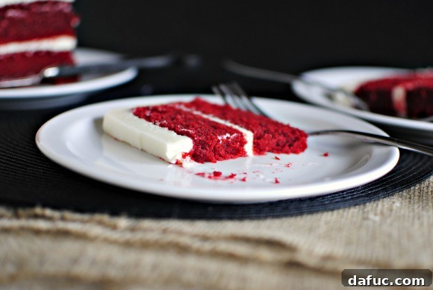 Timeless Red Velvet Cake 33 A close-up shot of a single bite of Classic Red Velvet Cake, showcasing its texture and the creamy frosting, inviting indulgence.