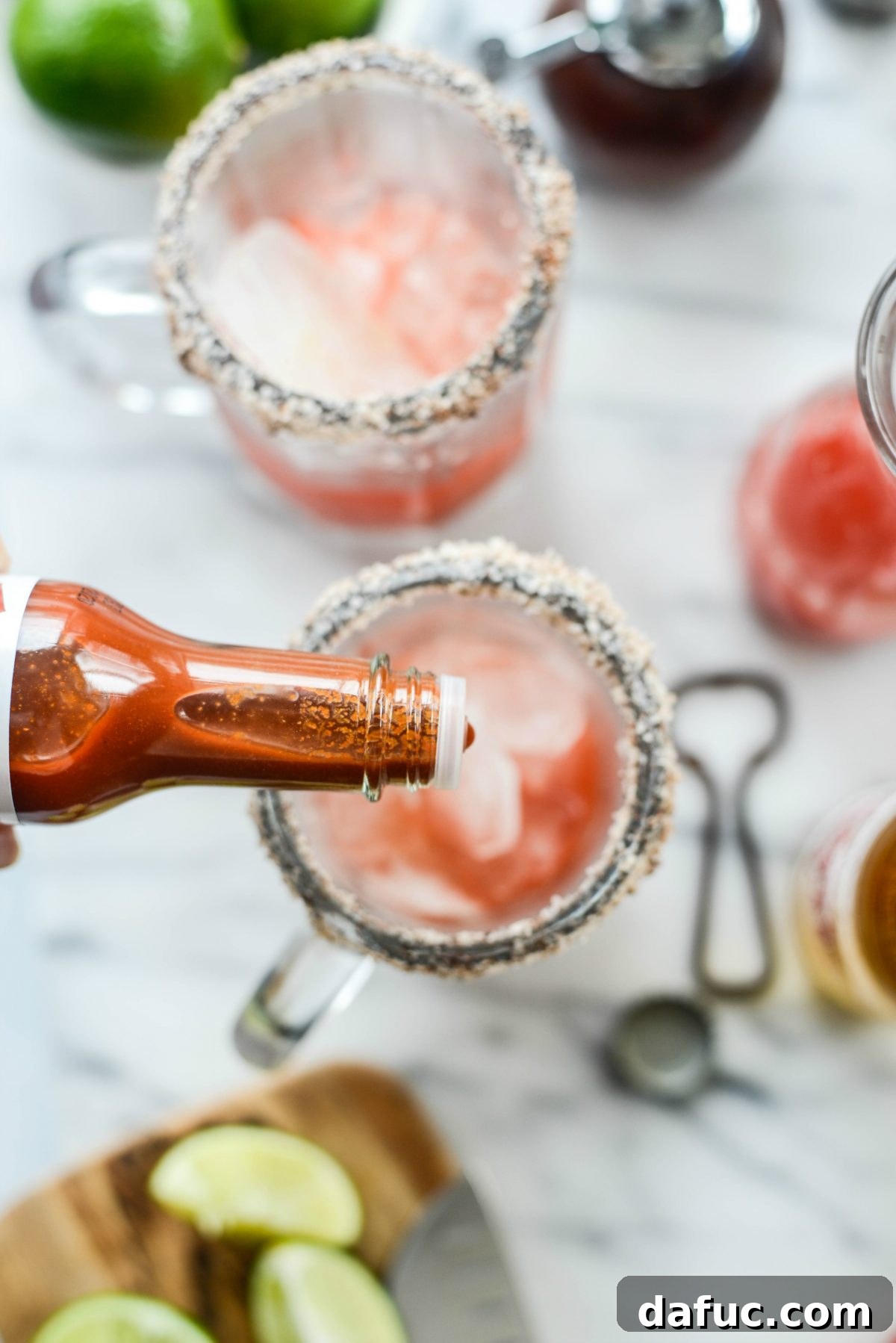 Adding Worcestershire sauce and coconut aminos to the Michelada mix