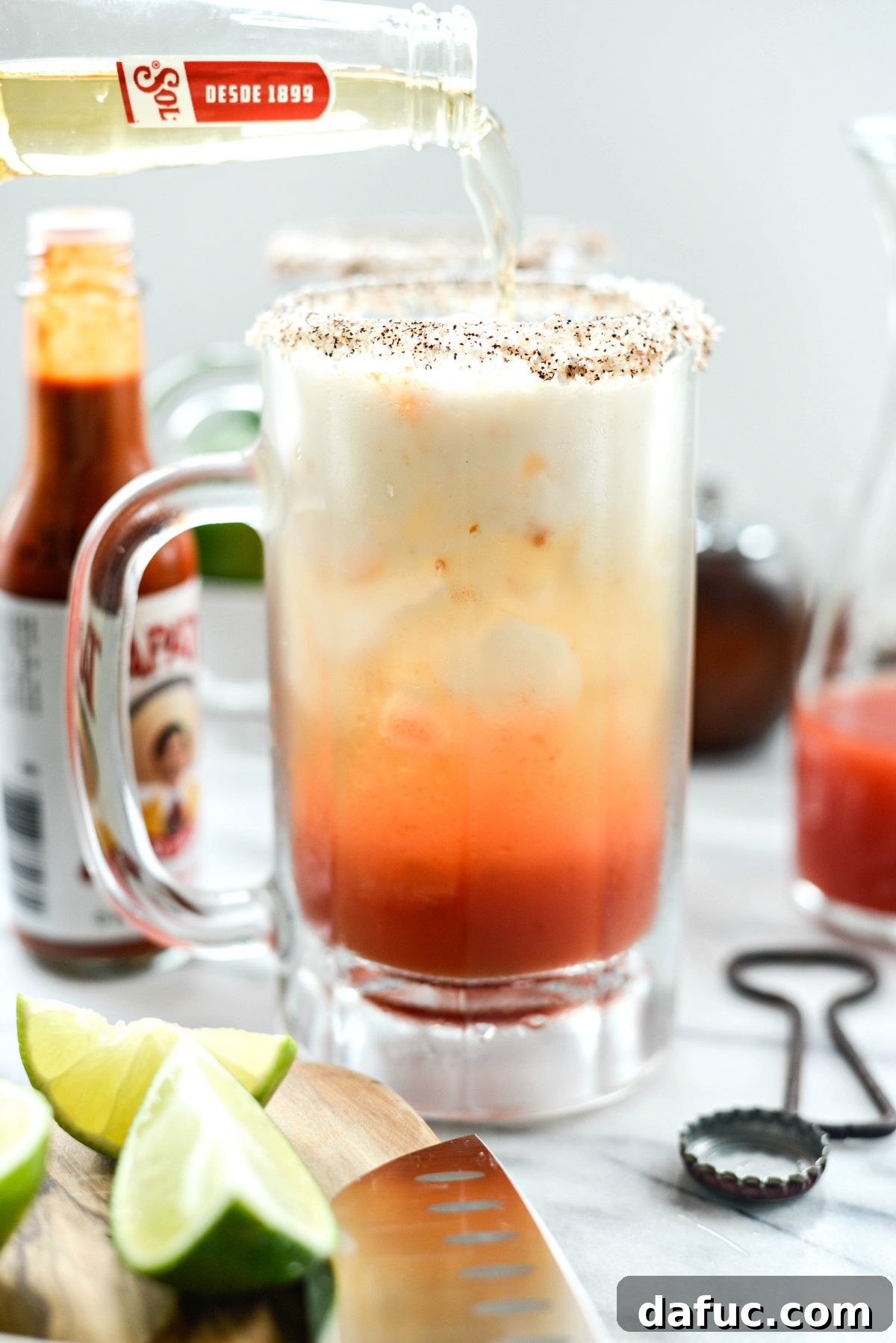 The Ultimate Mexican Michelada Recipe 16 Pouring Mexican beer into the Michelada glass, topping it off to the rim