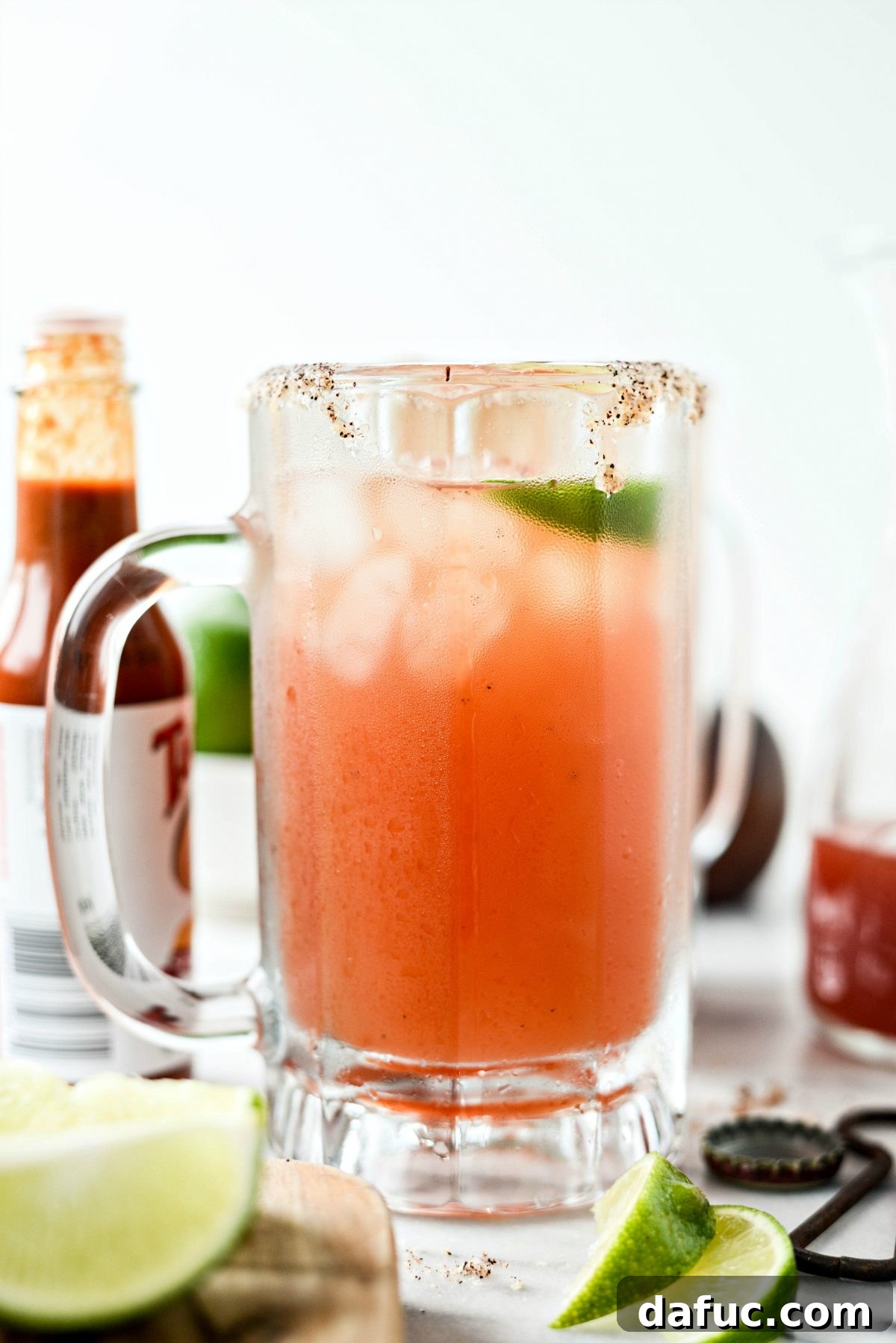 A refreshing sip of a Mexican Michelada with the chili-salt rim visible