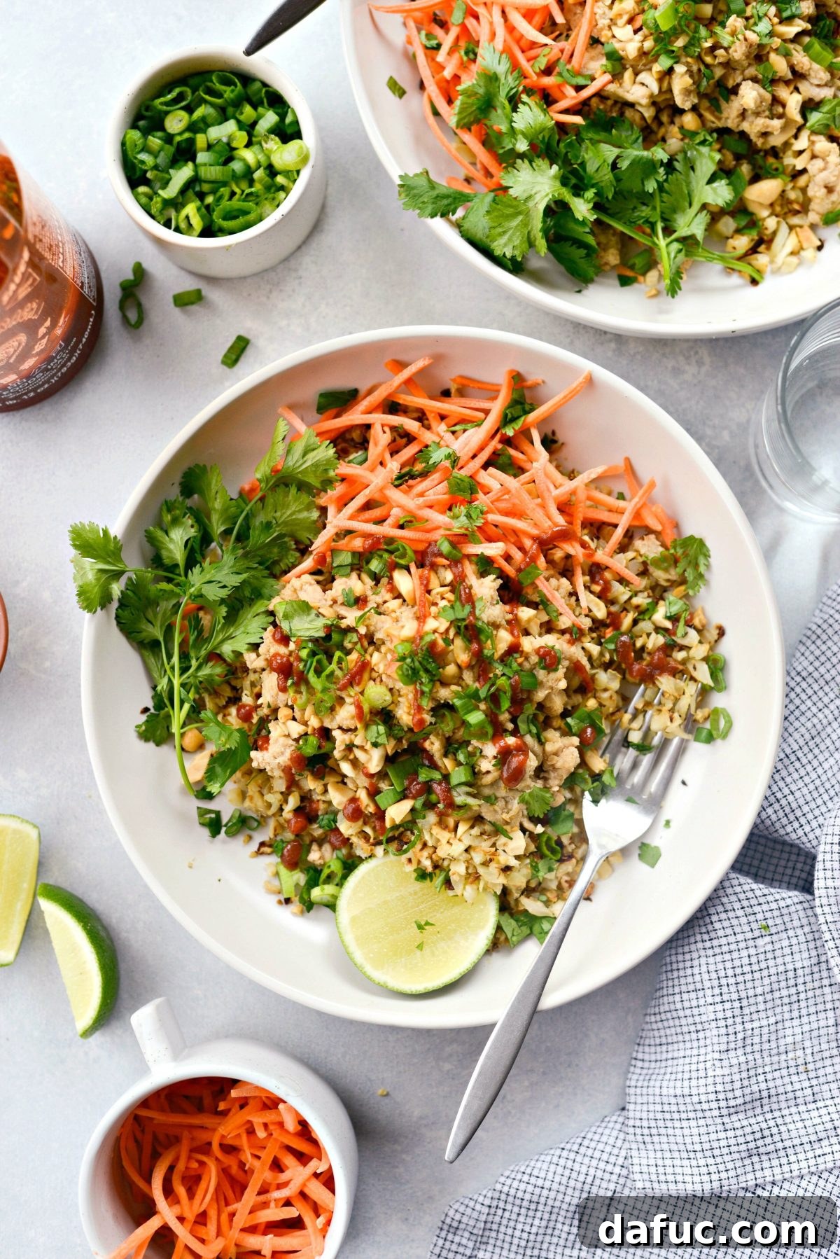 A beautifully assembled Thai Chicken Cauliflower Rice Bowl with fresh toppings