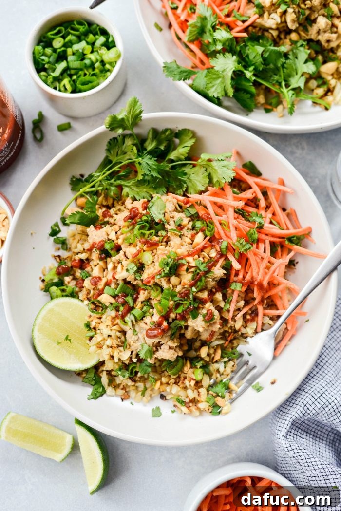A vibrant Quick Thai Chicken Cauliflower Rice Bowl with chopsticks, ready to be enjoyed