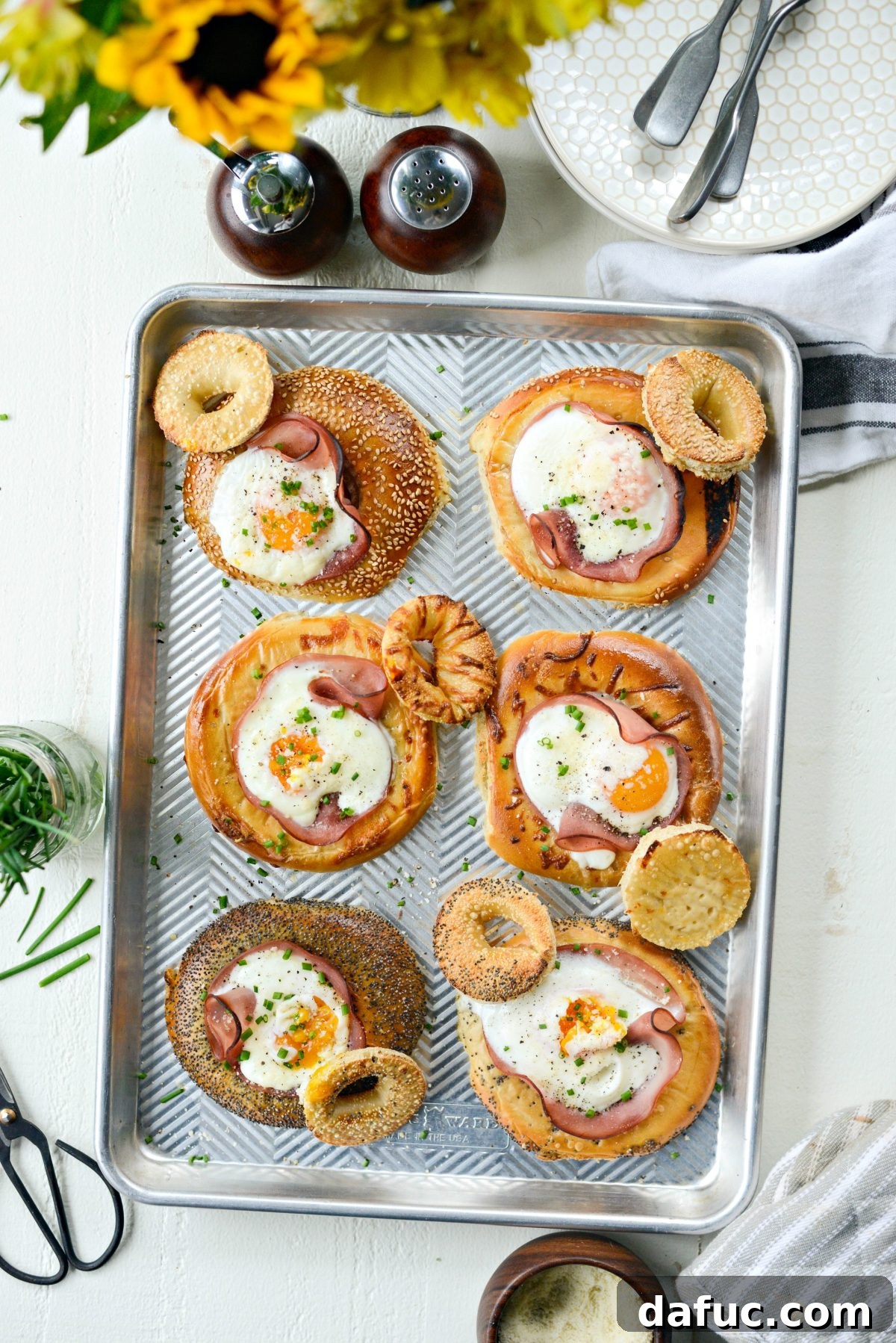 Bagel Egg Nests 15 A close-up of a baked egg in a hole bagel on a sheet pan