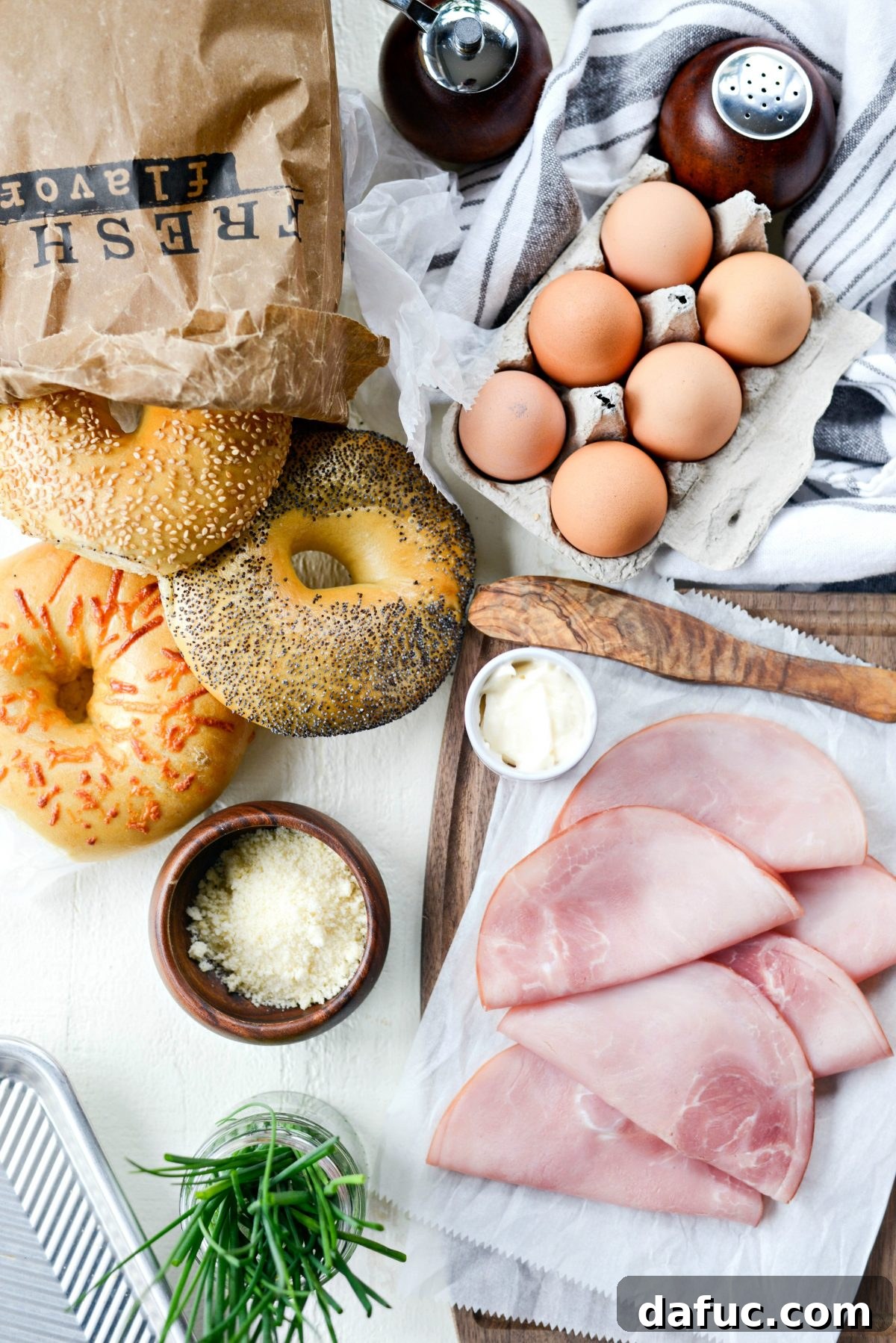 Bagel Egg Nests 4 Ingredients for Baked Egg in a Hole Bagels laid out on a cutting board