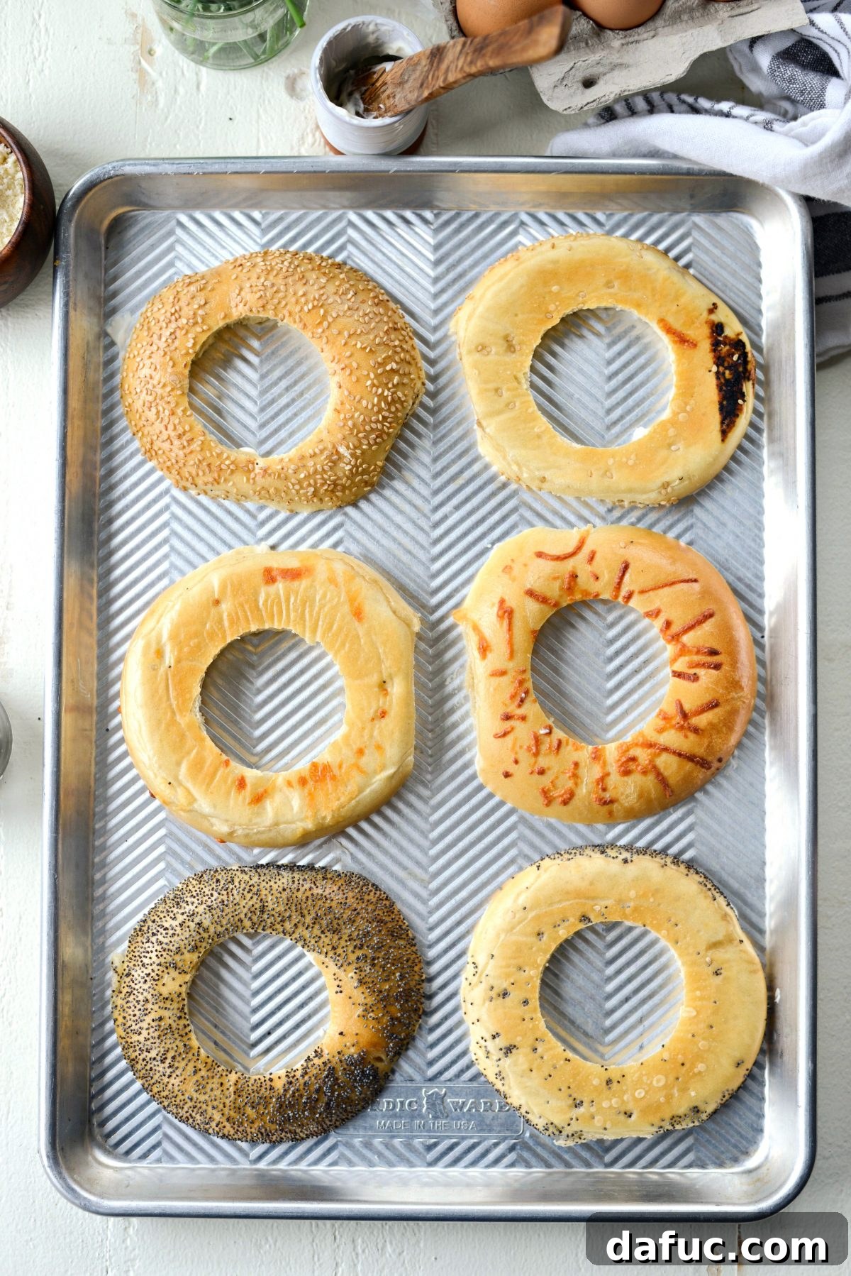 Bagel Egg Nests 10 Bagel halves with mayonnaise are pressed onto a rimmed sheet pan
