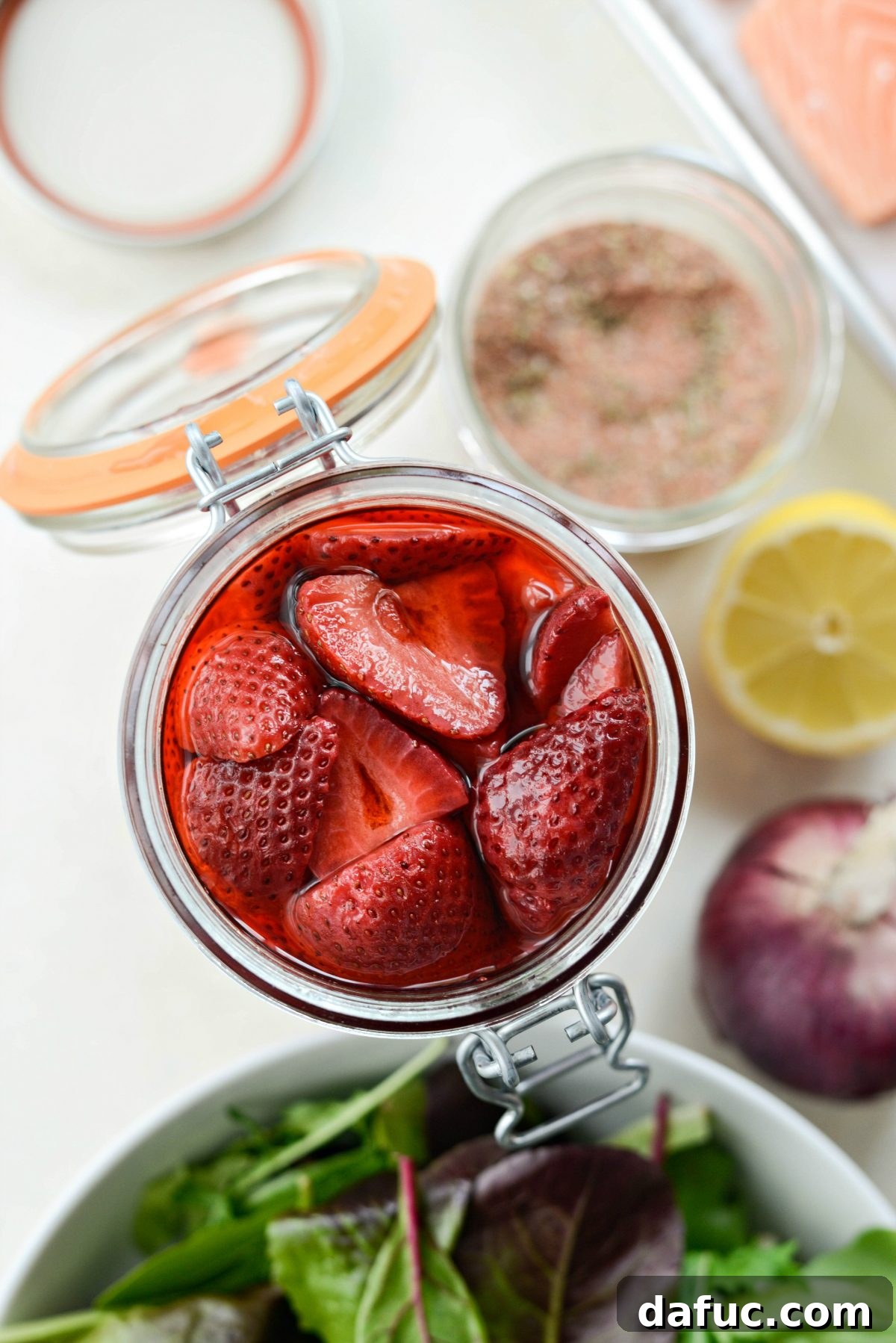Vinegar-Kissed Strawberries 13 Blackened Salmon Salad with Strawberry Peppercorn Vinaigrette, featuring pickled strawberries as a key ingredient.