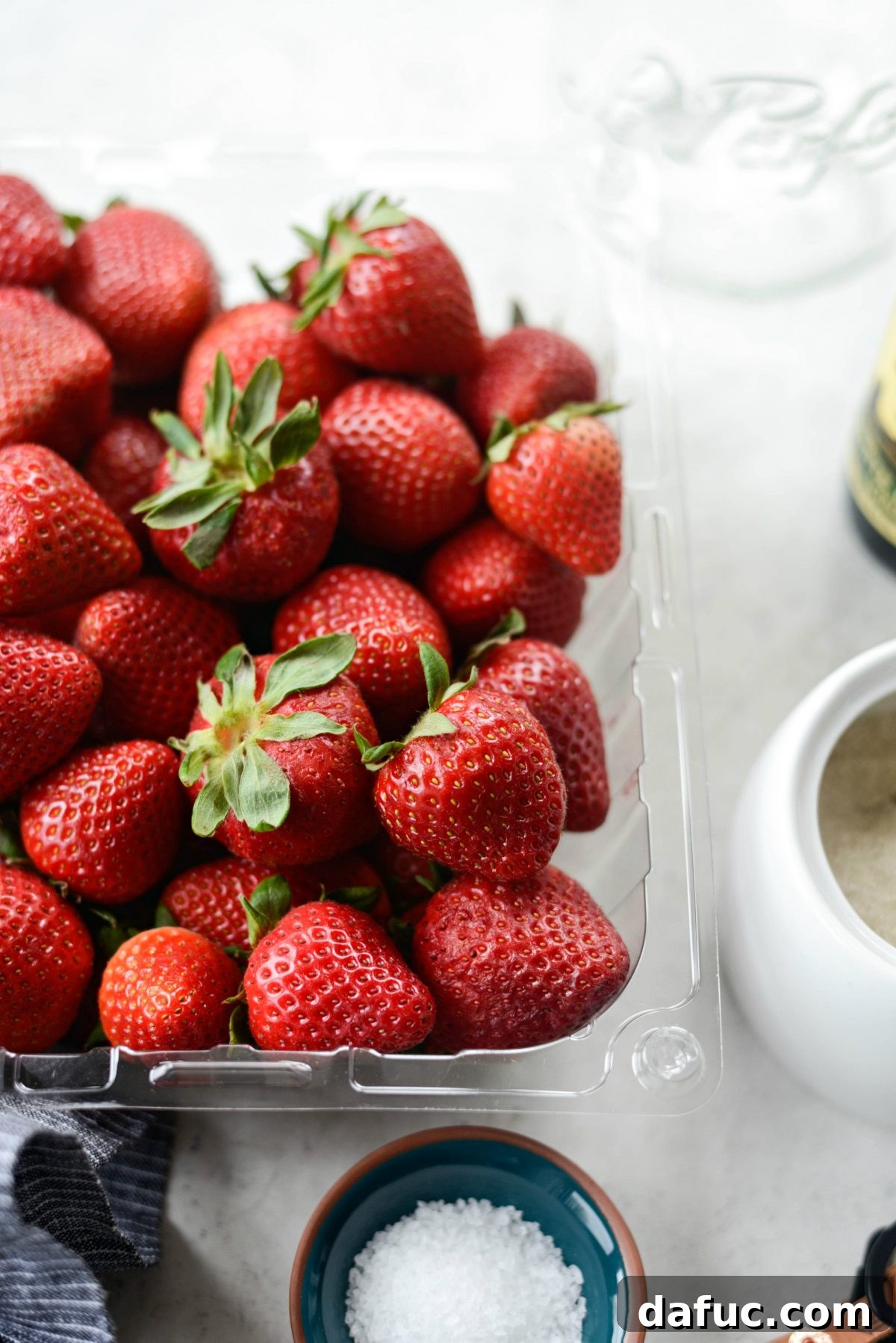 Vinegar-Kissed Strawberries 8 Prepared strawberries, with some halved, ready to be placed into the pickling jar.