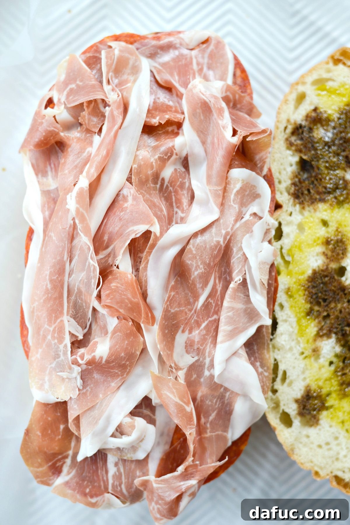 Pressed Italian Perfection 11 Layer prosciutto slices last among the meats.