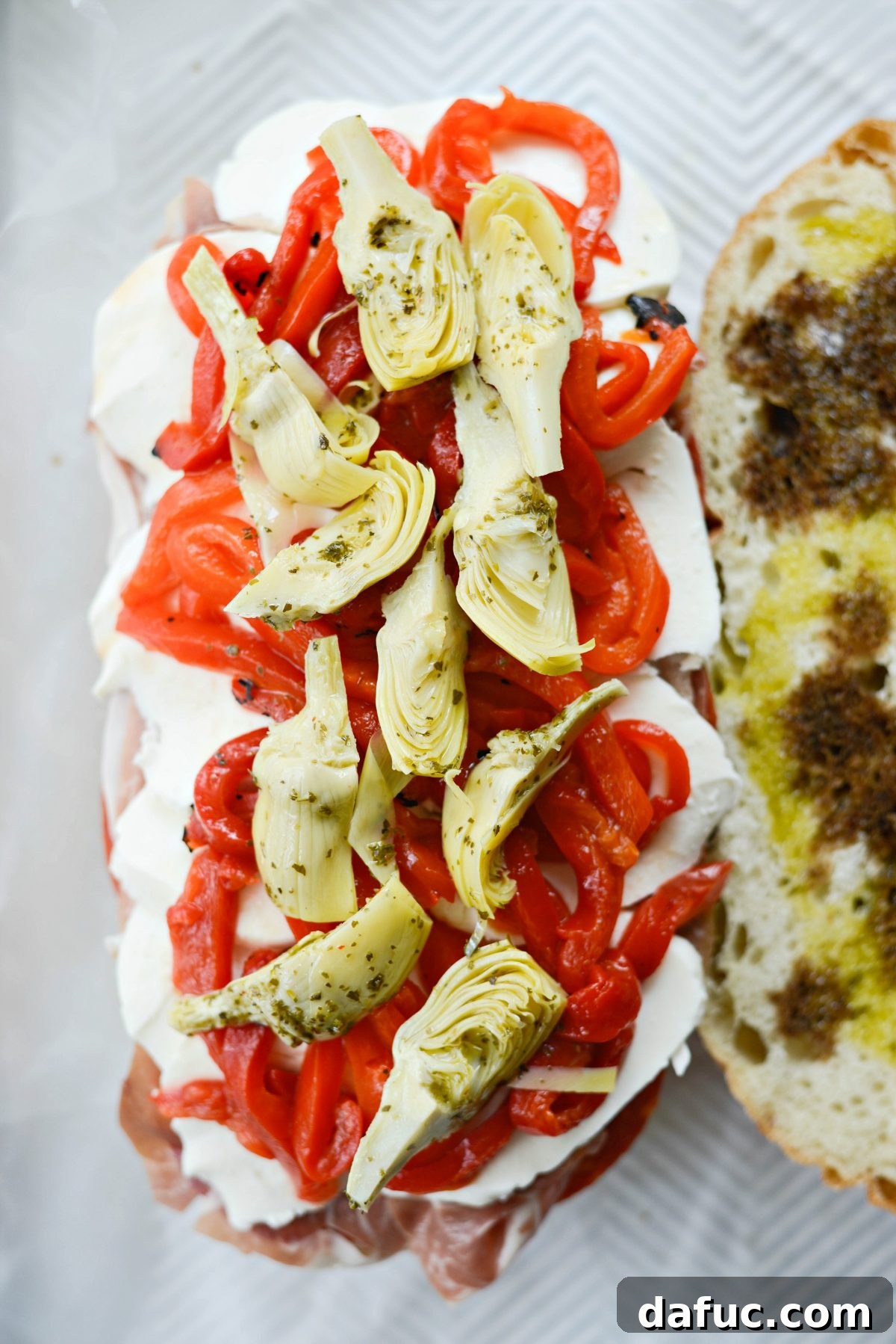 Pressed Italian Perfection 12 Fresh mozzarella, roasted red peppers, and marinated artichokes layered.