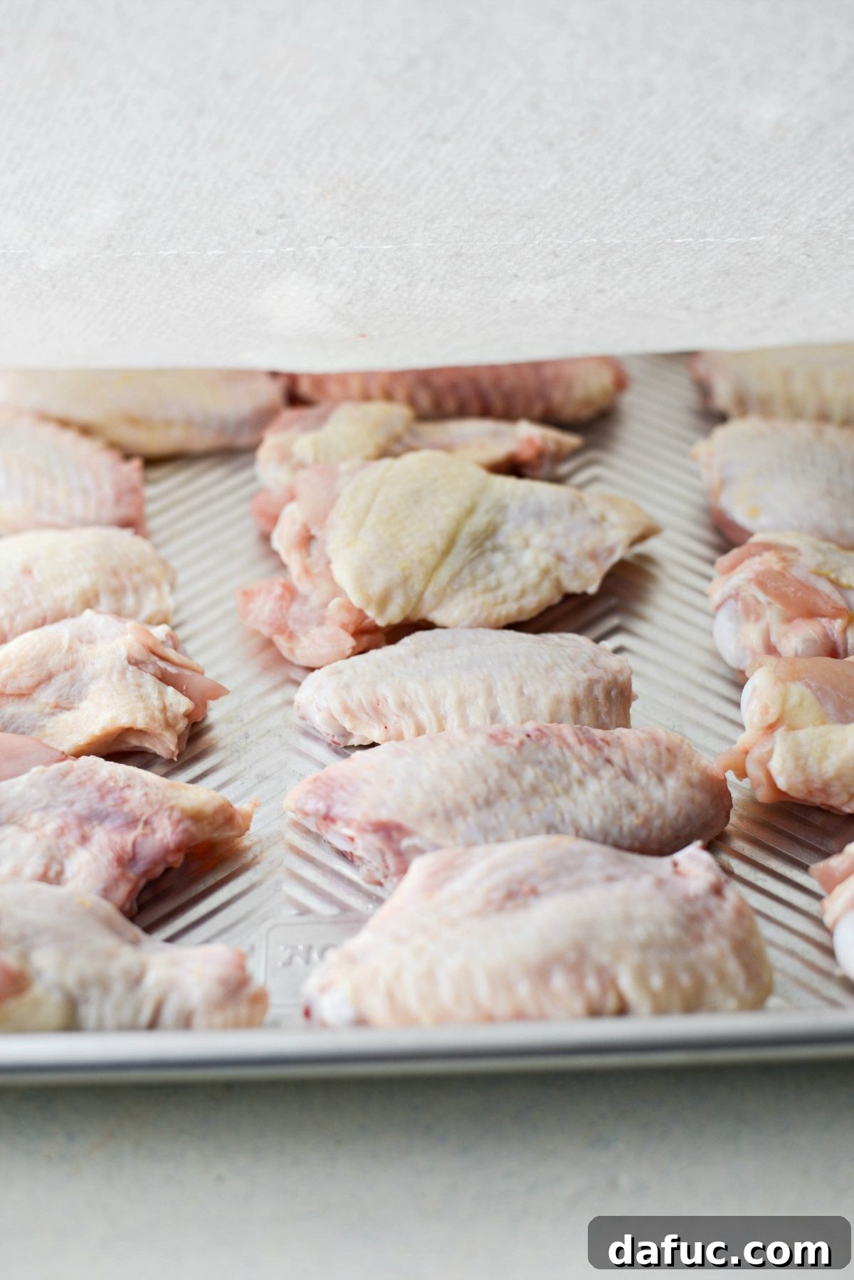 Sweet & Smoky Cherry Chipotle Wings 11 Patting chicken wings dry with a paper towel for crispy skin