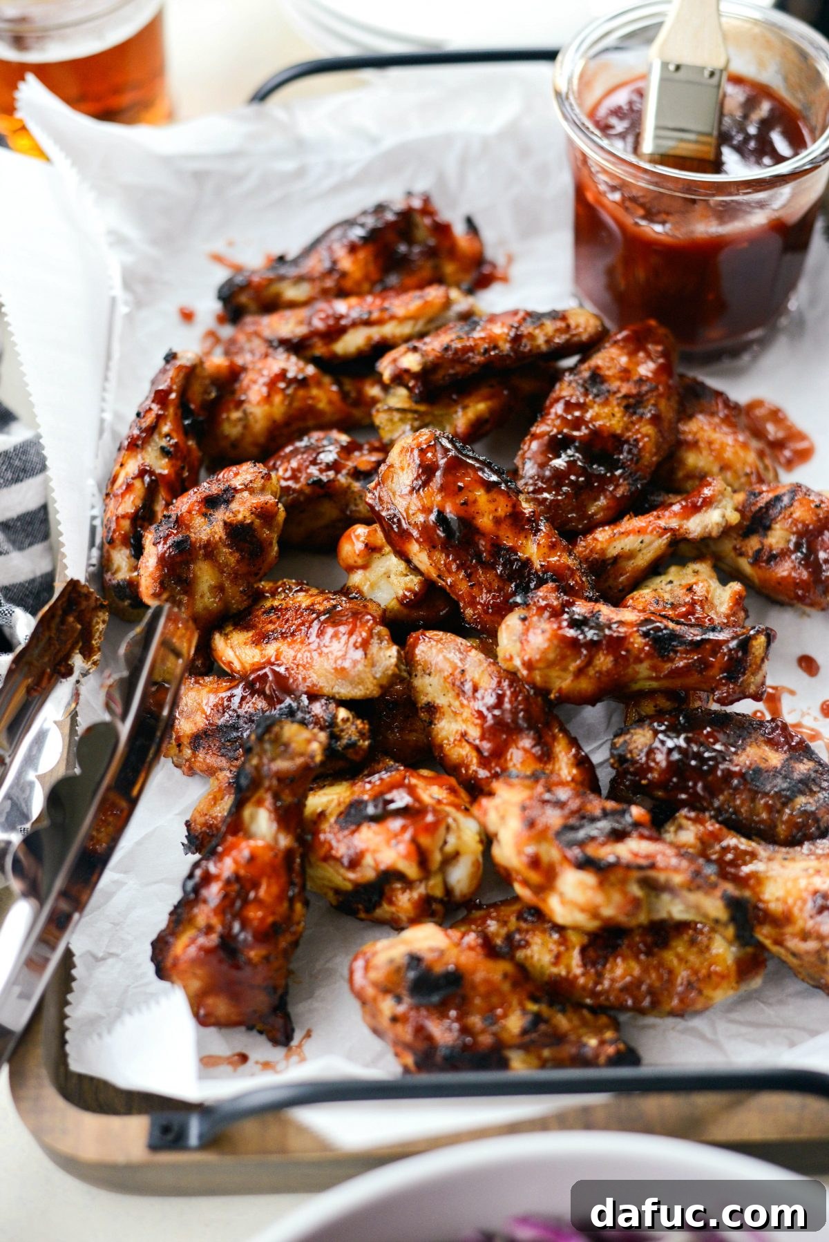 Sweet & Smoky Cherry Chipotle Wings 3 Close-up of a plate of Grilled Cherry Chipotle Chicken Wings, showcasing their sauciness
