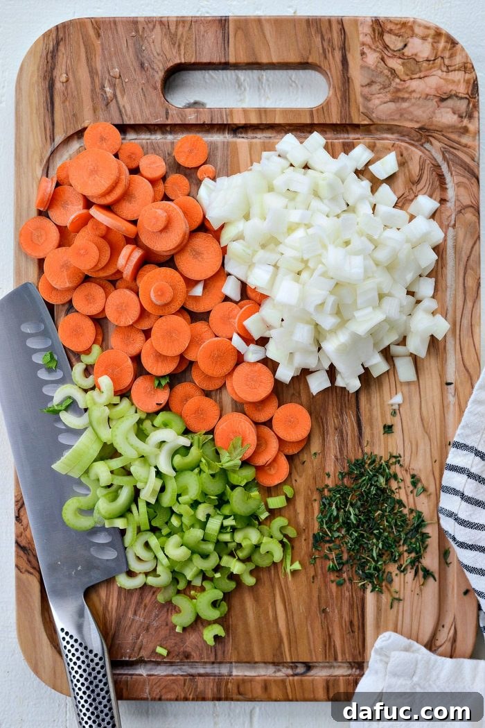 Fresh vegetables and herbs prepped for making chicken noodle soup