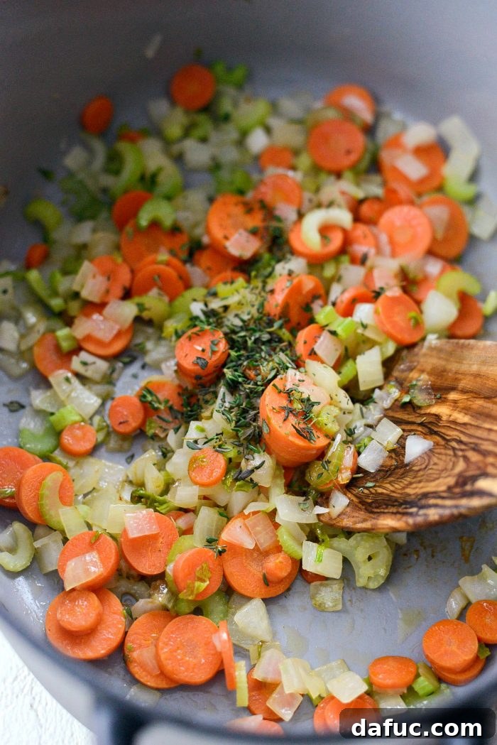 Sautéing diced vegetables in olive oil in a Dutch oven