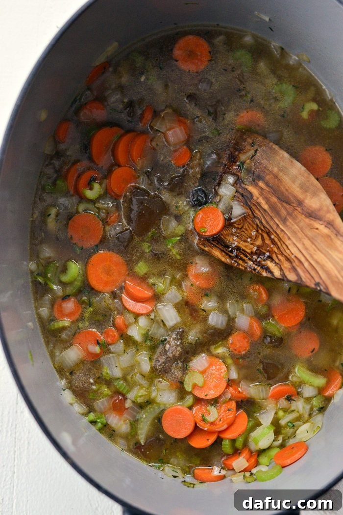 Adding fragrant fresh thyme to sautéed vegetables