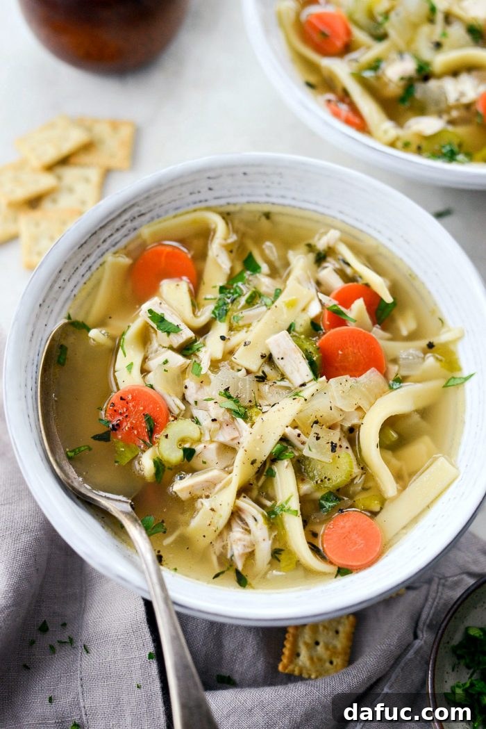 Hearty chicken noodle soup simmering in a pot, ready to serve
