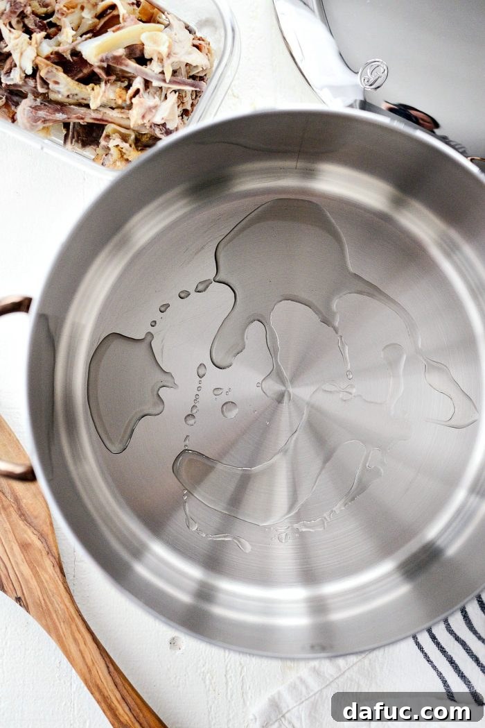 Browning chicken bones in a large pot for homemade stock