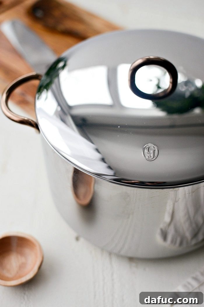 Chicken bones, vegetables, and water simmering in a large stockpot