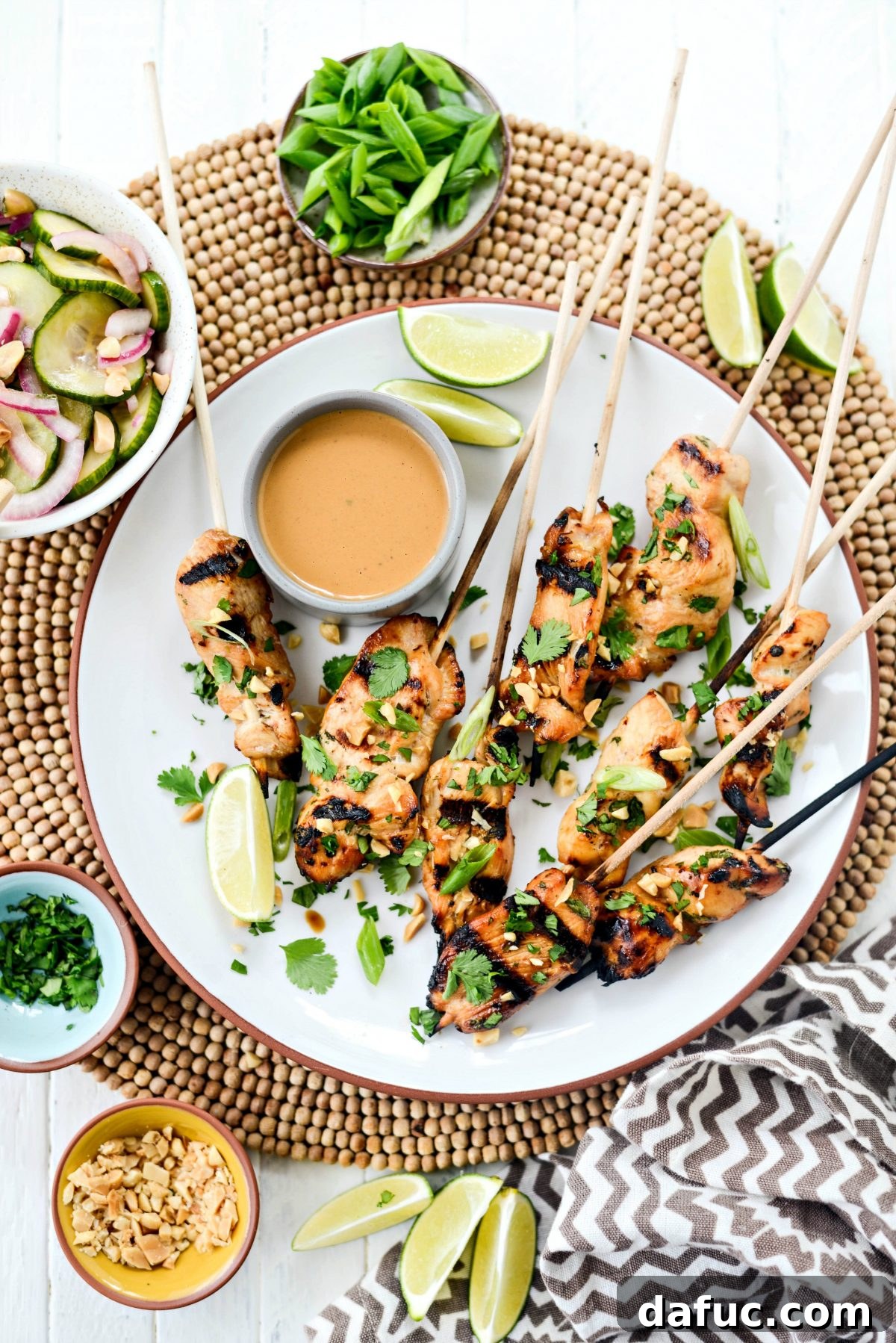 Thai Chicken Satay Skewers with Creamy Peanut Sauce 19 Beautifully presented Chicken Satay with Thai Peanut Sauce on a white dish