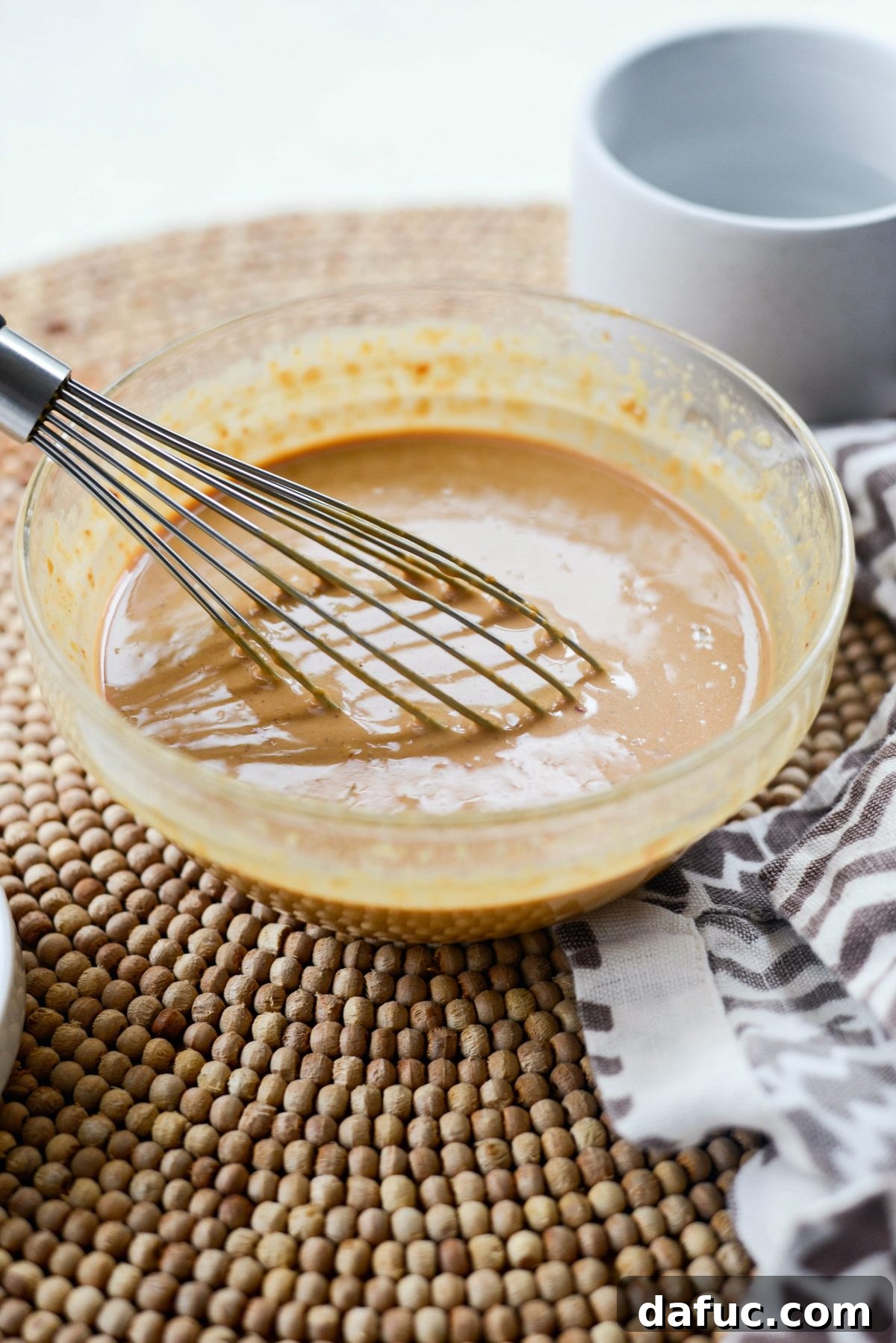 Thai Chicken Satay Skewers with Creamy Peanut Sauce 5 Mixing bowl with whisked Thai Peanut Sauce
