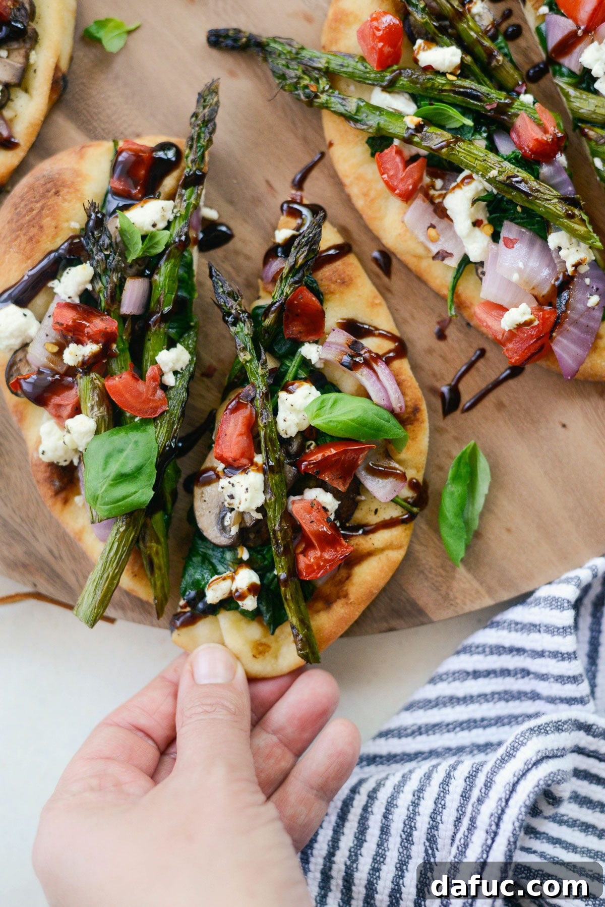 Vegetable and Goat Cheese Flatbread served on a platter with glasses.