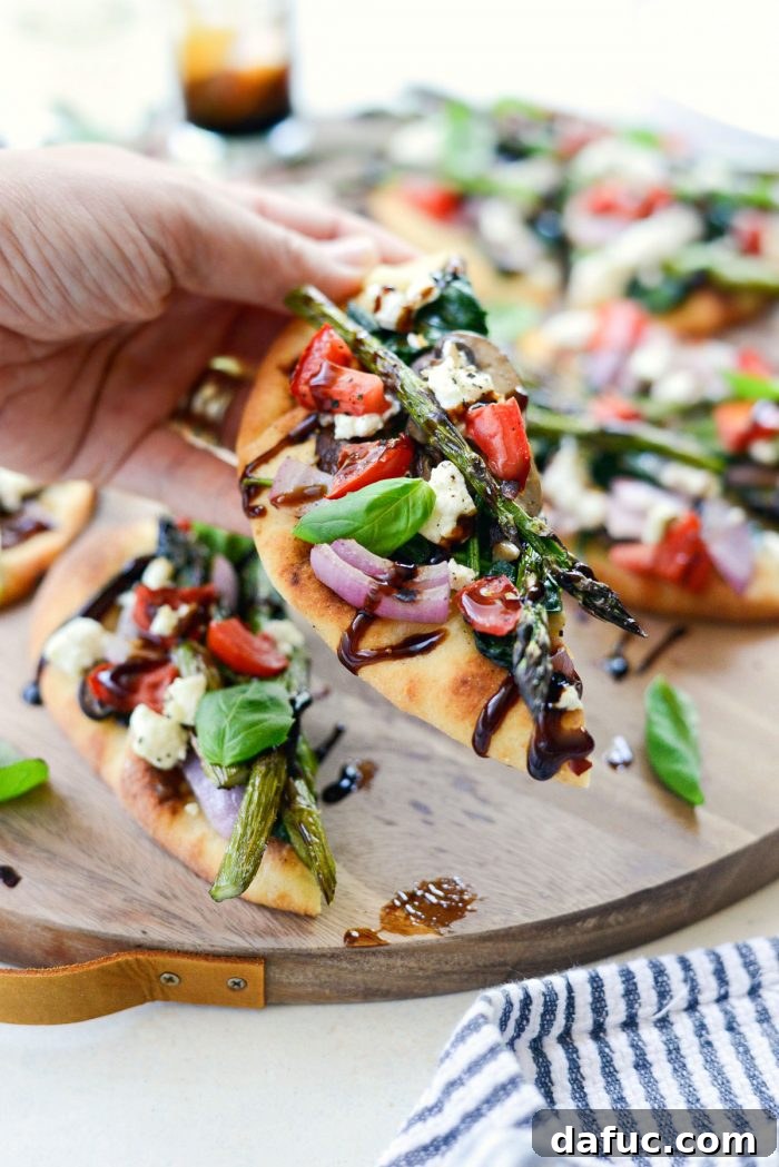 Friends sharing Vegetable and Goat Cheese Flatbread, emphasizing its communal aspect.