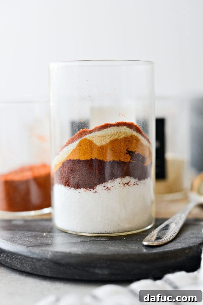 Measured spices in a glass jar, ready for mixing to create the seasoning blend