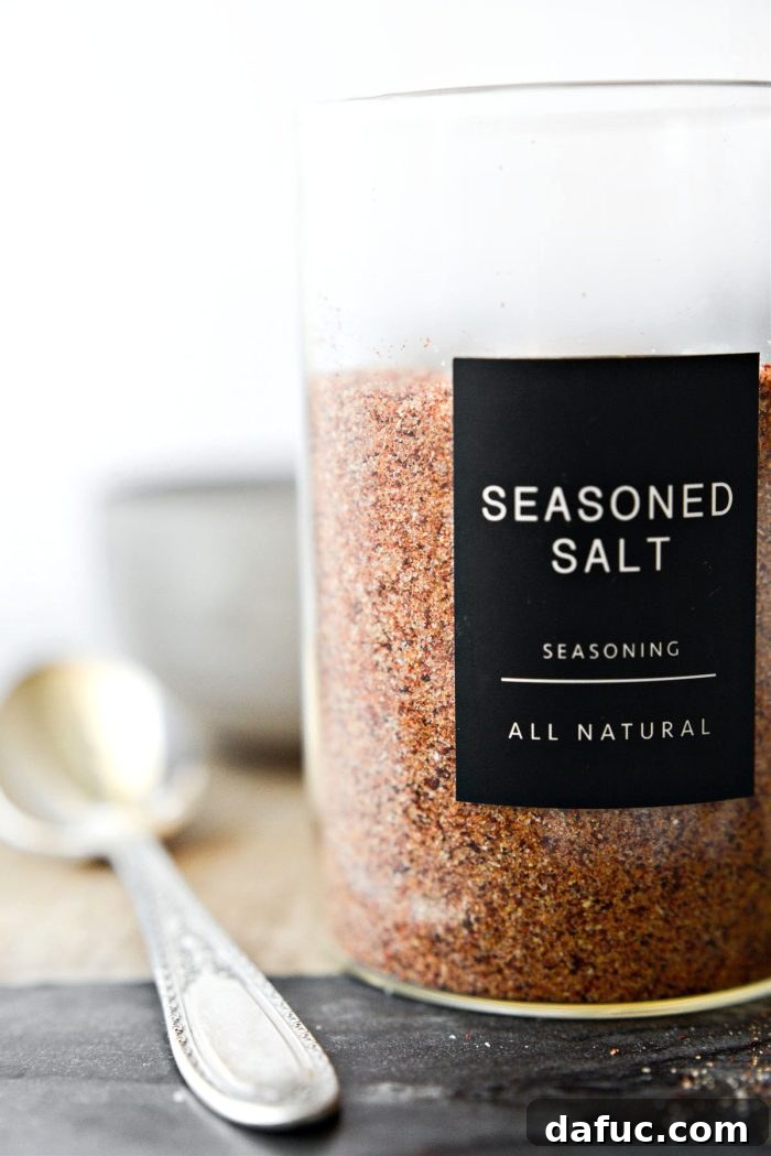 A jar of homemade all-purpose seasoning salt with a tag, ready for use