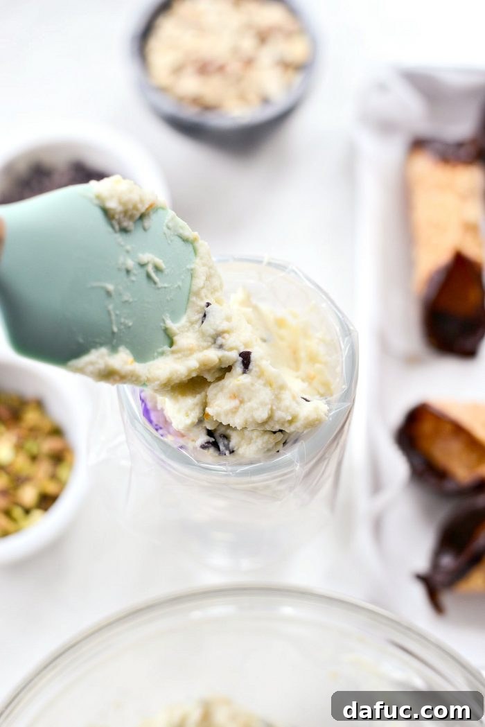 Piping bag filled with cannoli ricotta mixture.