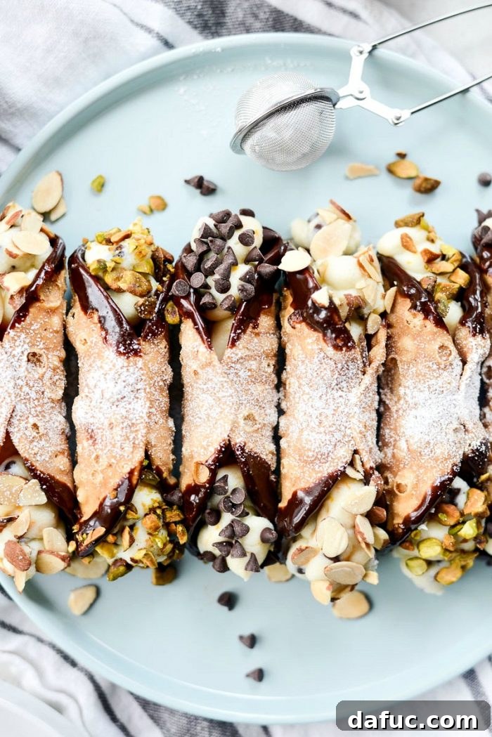 A close-up of a perfectly filled and garnished homemade cannoli.