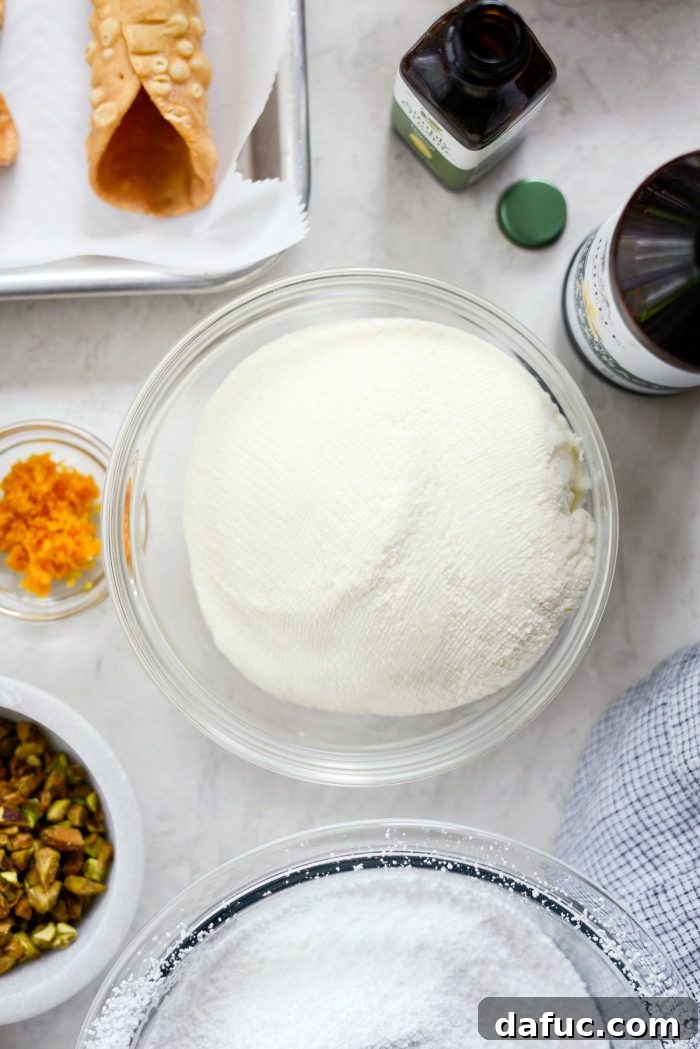 Preparing ricotta cheese for cannoli filling.
