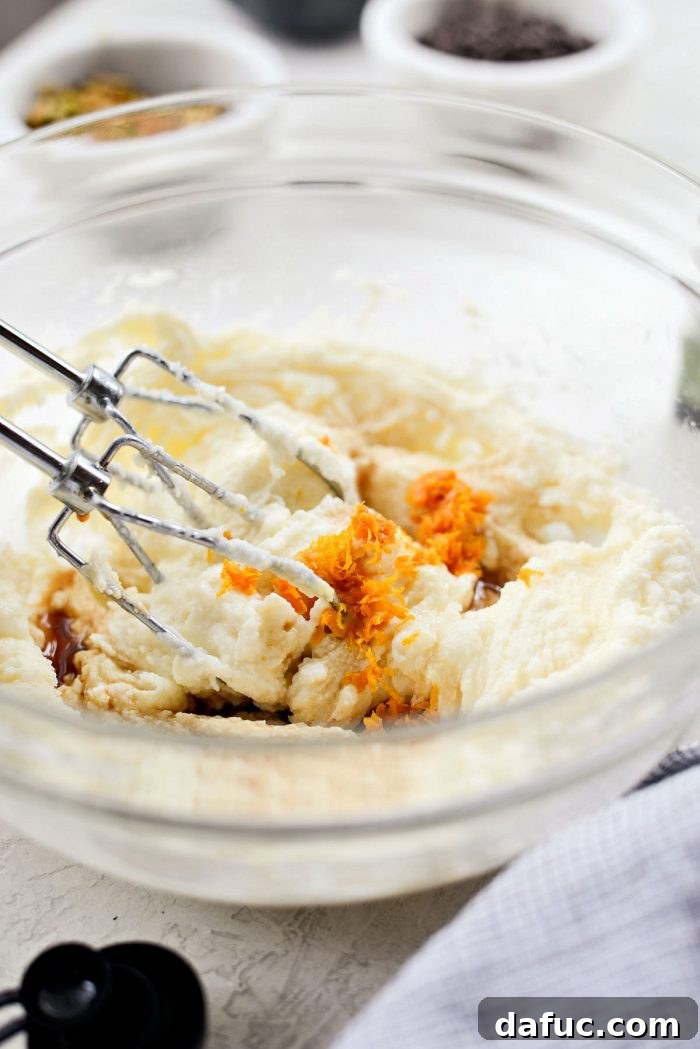 Mixing ricotta cheese, powdered sugar, and extracts for cannoli filling.
