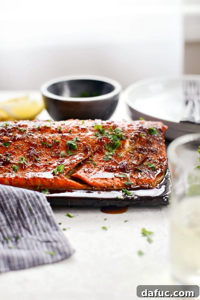 Signature Grilled Whiskey Glazed Cedar Plank Salmon 2 Delicious Grilled Whiskey Glazed Cedar Plank Salmon with fresh herbs, perfect for summer entertaining