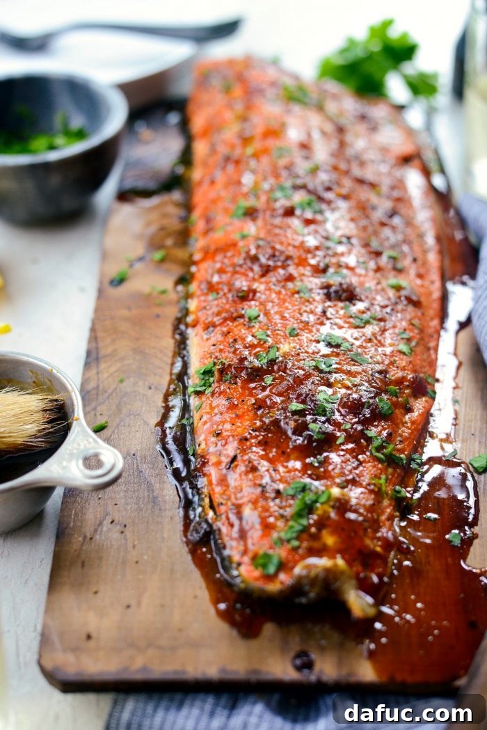 Signature Grilled Whiskey Glazed Cedar Plank Salmon 16 Transferring cedar plank salmon from grill to a sheet pan