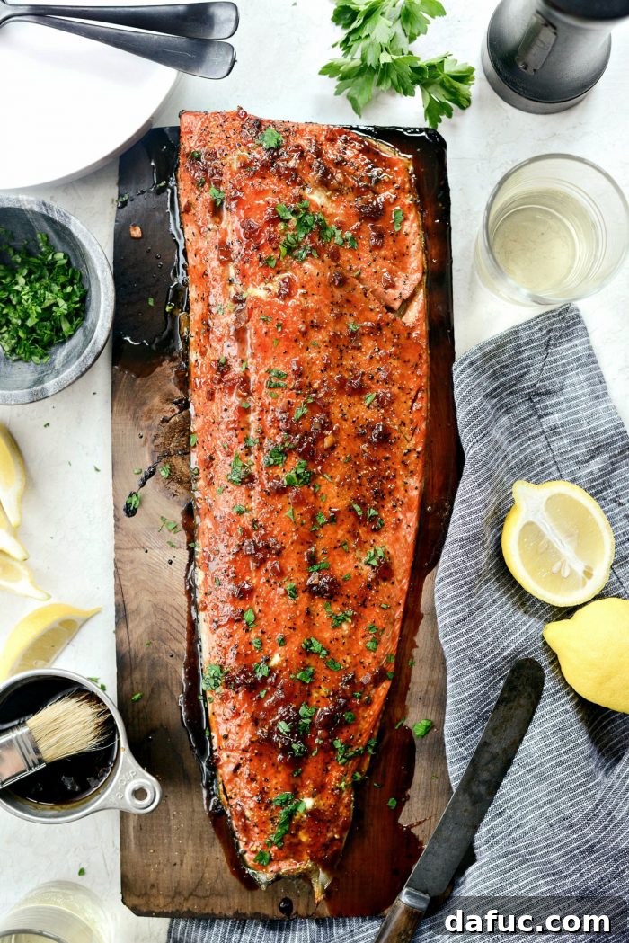 Signature Grilled Whiskey Glazed Cedar Plank Salmon 3 Close-up of freshly grilled cedar plank salmon with golden whiskey glaze