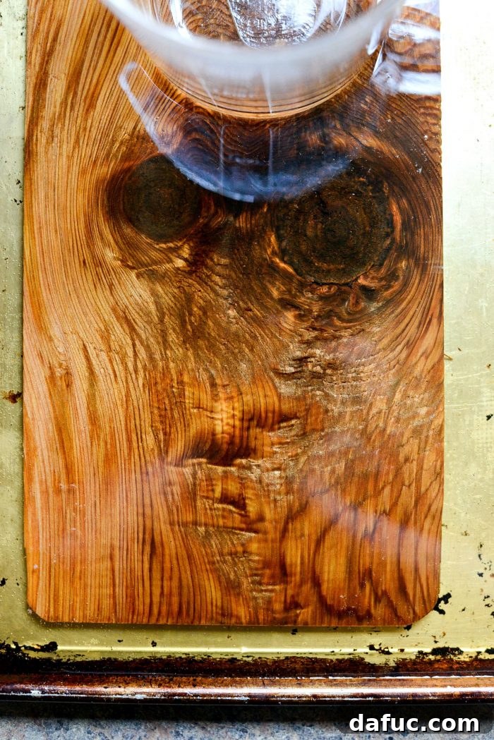 Signature Grilled Whiskey Glazed Cedar Plank Salmon 5 Ingredients for cedar plank salmon including a cedar plank, salmon fillet, and seasoning