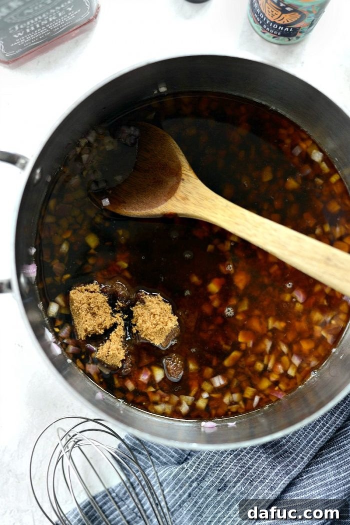 Signature Grilled Whiskey Glazed Cedar Plank Salmon 8 Whiskey glaze ingredients being mixed in a saucepan on the stove
