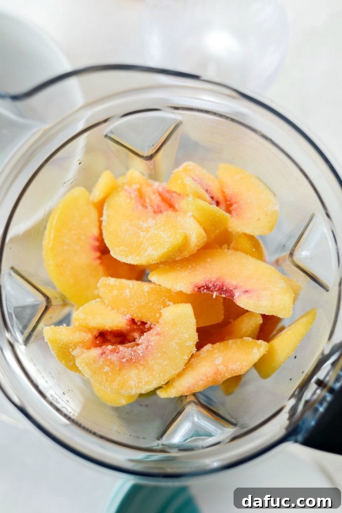 Blushing Peach Dream 7 Adding frozen peaches to the blender for the Frosé.