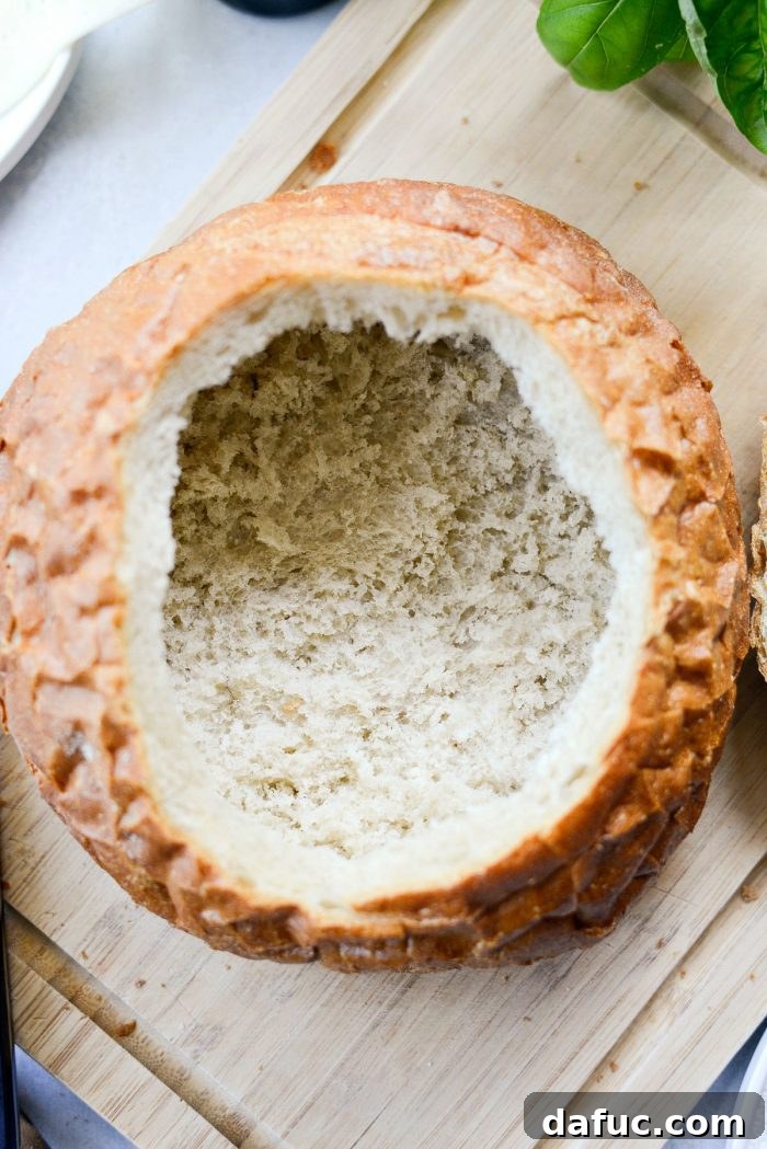 Hollowing out the bread boule by hand.