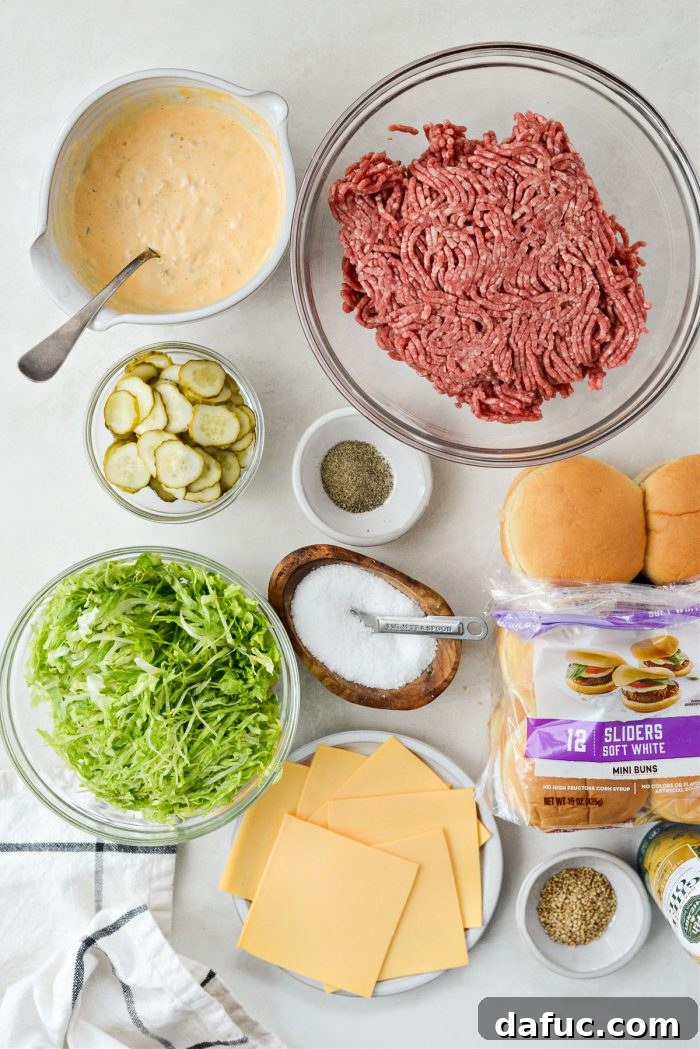 Mac Mini Bites 4 Fresh ingredients laid out for homemade Mini Mac Sliders, including ground beef, cheese slices, lettuce, pickles, and buns.