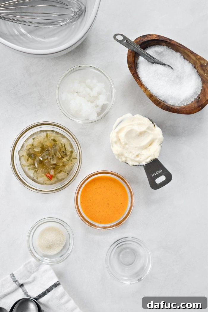 Mac Mini Bites 5 Individual ingredients for homemade Mac sauce laid out, including mayonnaise, relish, French dressing, onion, and spices.