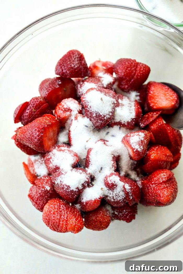 Fresh Strawberry Shortcake 17 Sliced fresh strawberries being tossed with lavender sugar for macerating.