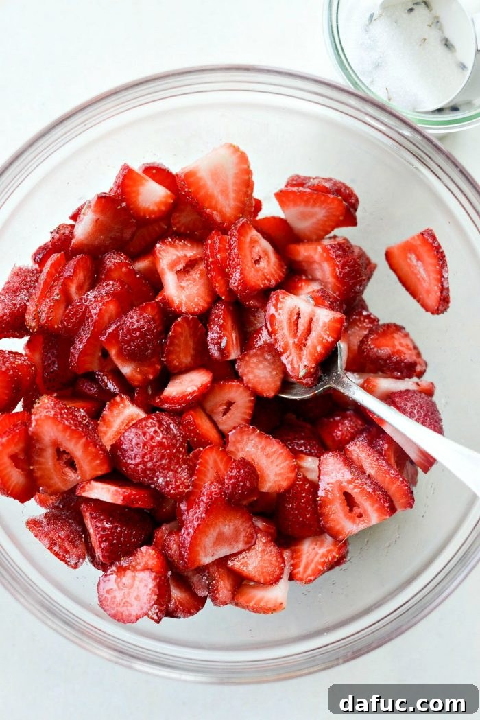 Fresh Strawberry Shortcake 18 Macerated lavender strawberries in a bowl, showing their natural juices drawn out by sugar.