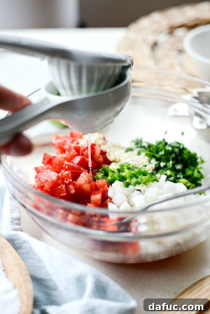 Easy Fresh Salsa 7 A chef's hand sprinkling kosher salt over freshly diced vegetables for Pico de Gallo, highlighting the seasoning step. #seasoning #kosher_salt #picodegallo_recipe