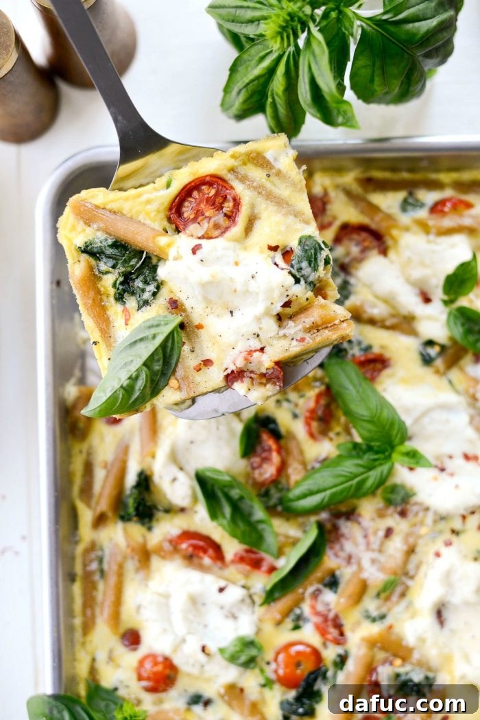 Mediterranean Sheet Pan Pasta Frittata 3 Sheet Pan Spinach Tomato Ricotta Pasta Frittata close-up, showcasing its hearty texture and colorful ingredients.