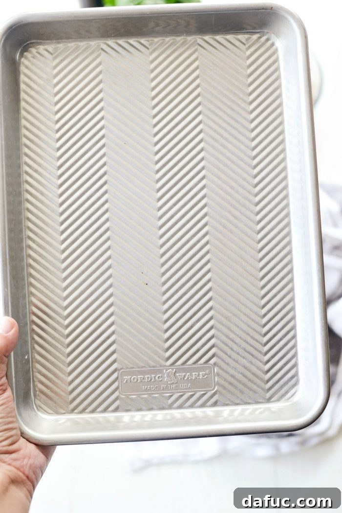 Mediterranean Sheet Pan Pasta Frittata 5 Quarter sheet pan heating in a preheated oven.