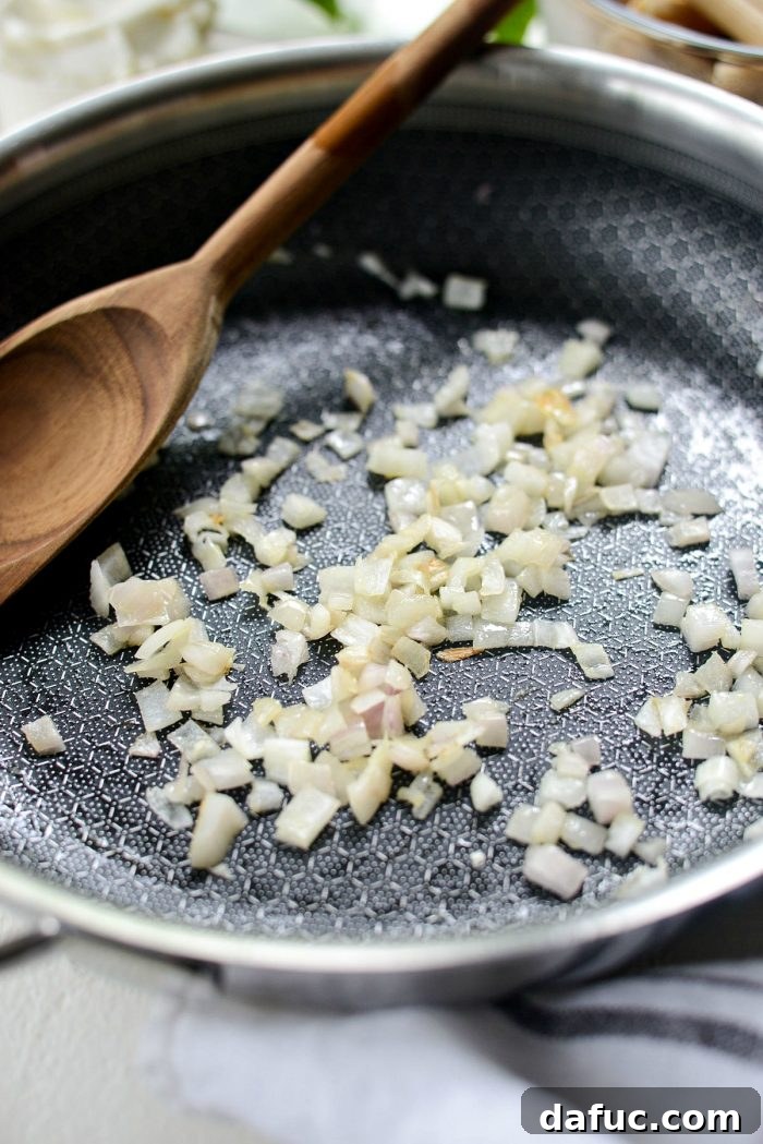Mediterranean Sheet Pan Pasta Frittata 6 Diced shallots sautéing in a skillet with olive oil.