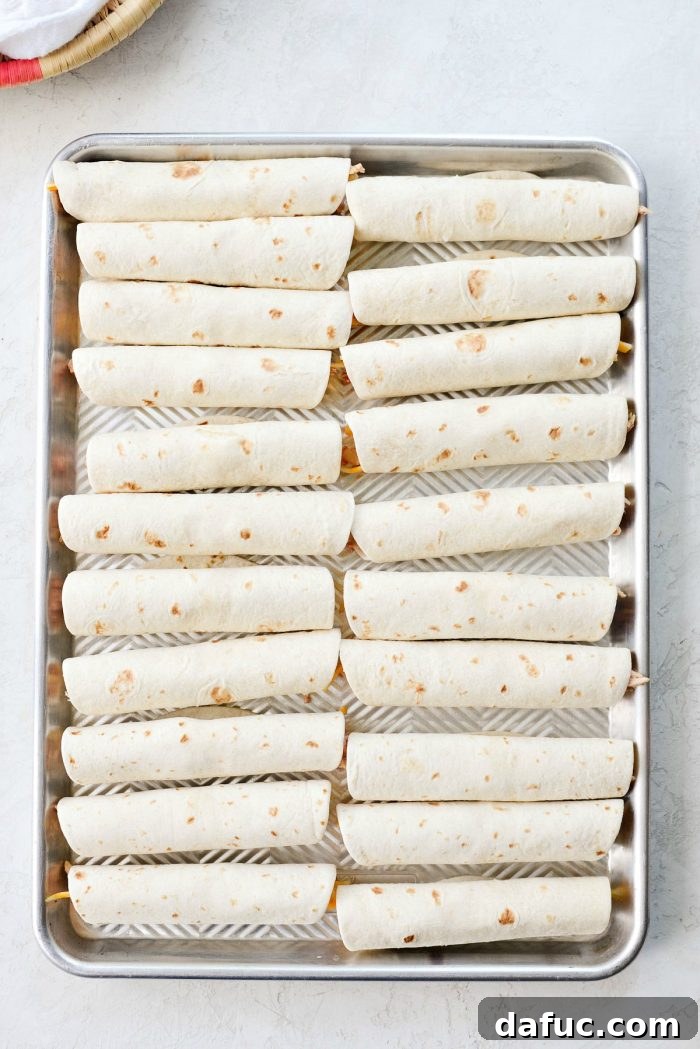 Zesty Air Fryer Salsa Chicken Taquitos 9 Rolling a taquito tightly after filling