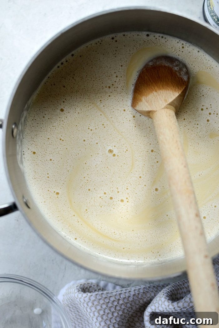 Golden Brown Butter Indulgence 12 Transferring the tempered ice cream base into a clean saucepan.