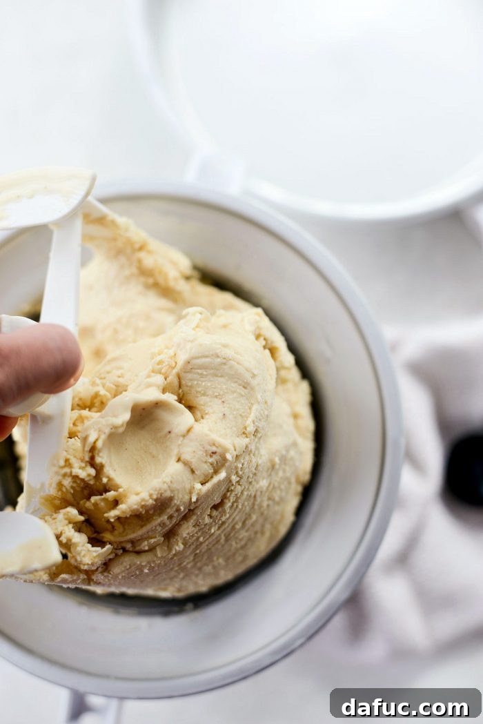 Golden Brown Butter Indulgence 22 Scraping the freshly churned ice cream from the paddle of the ice cream maker.